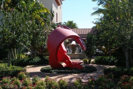 Abstract red statue in small, wooded courtyard